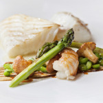 Hywel Jone's Dish Cornish day boat turbot, risotto of Jersey Royals, truffle butter poached langoustine, peas and girolles