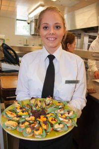 Student with mussels canapes